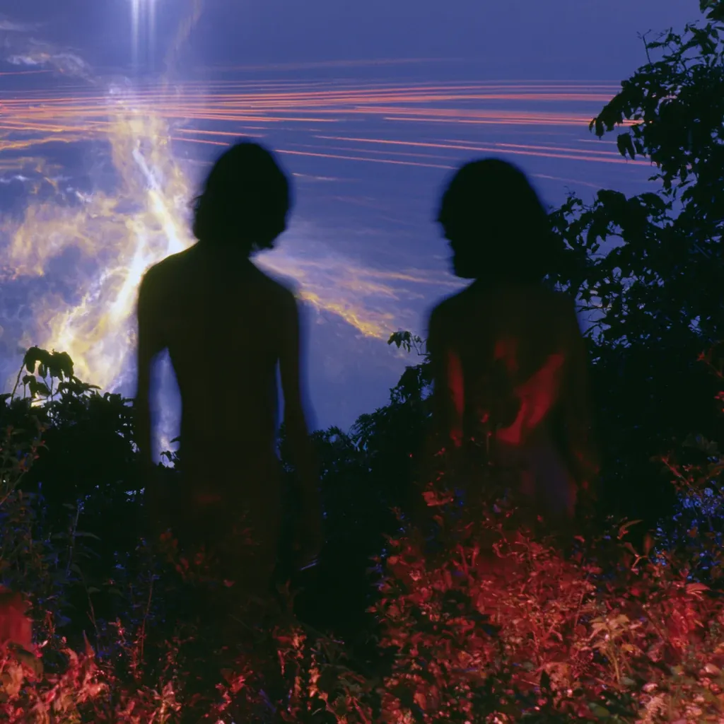 Adam and Eve see Eden — two figures in silhouette before a sky of light.